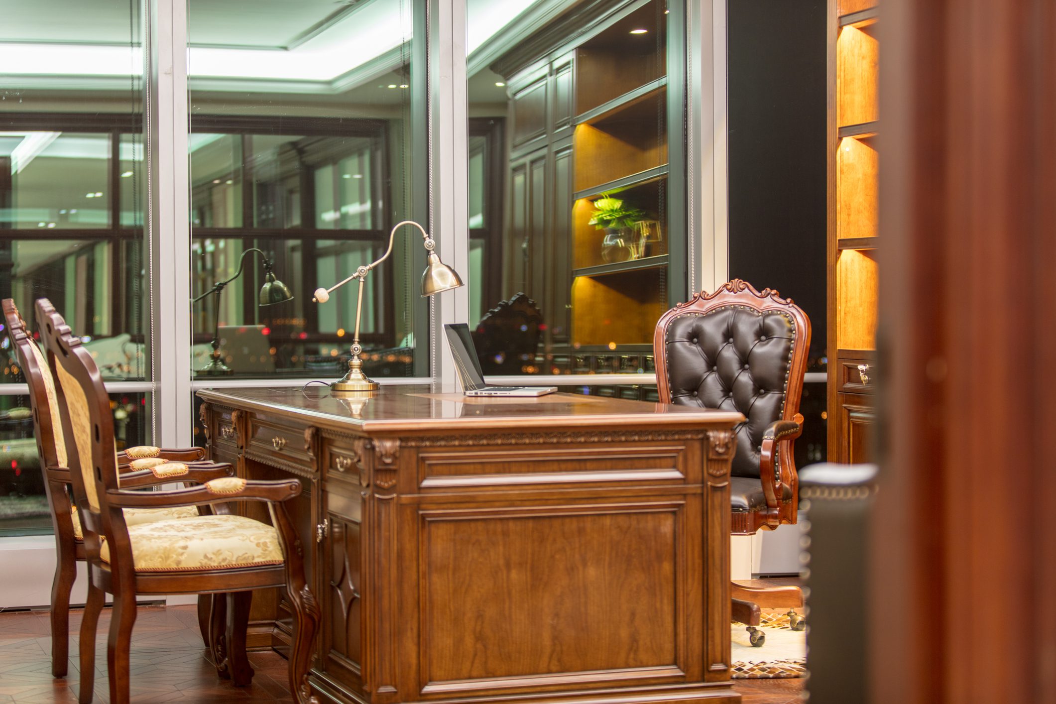 Ornate wooden executive desk with leather chair
