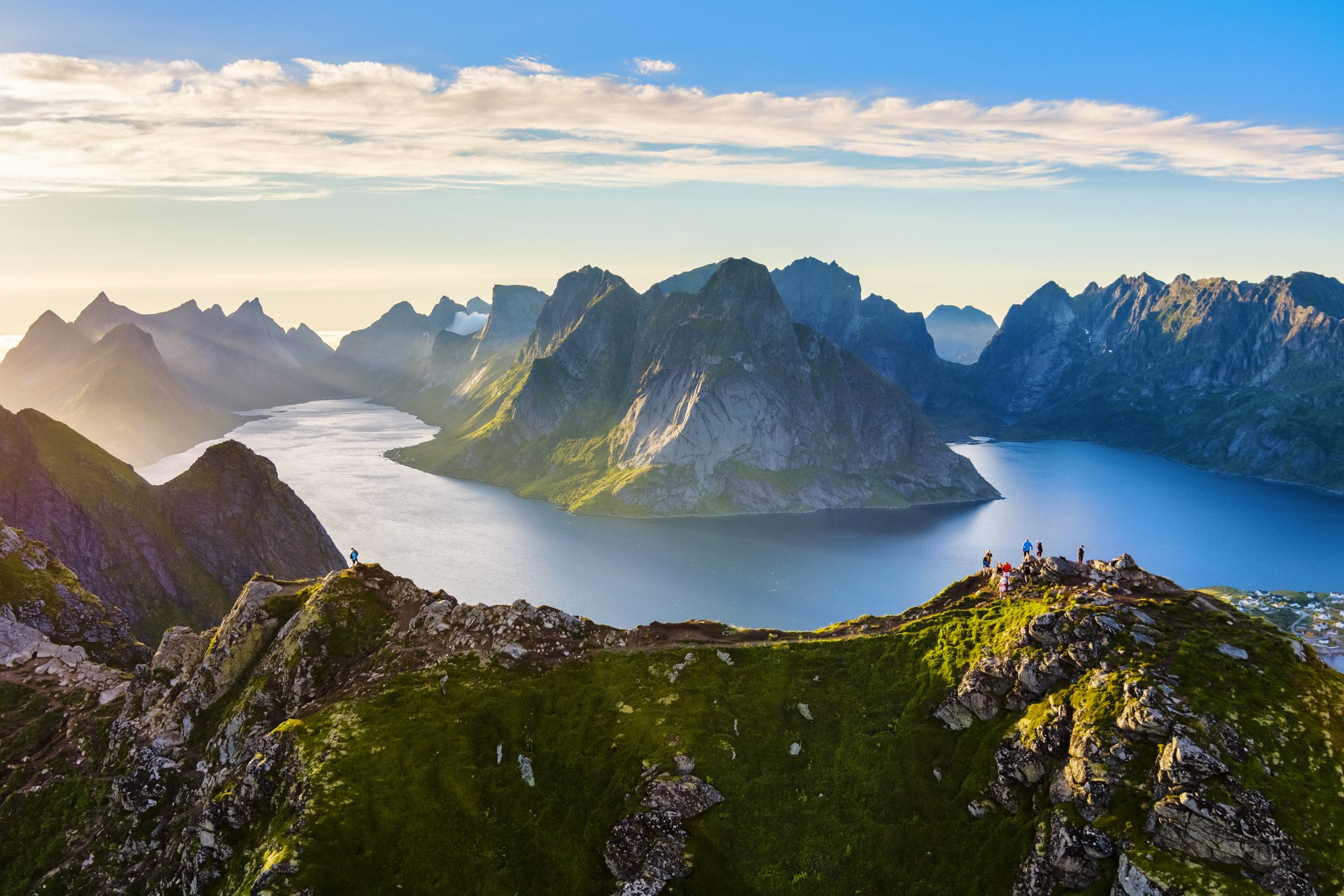 Hikers overlooking dramatic mountain fjord