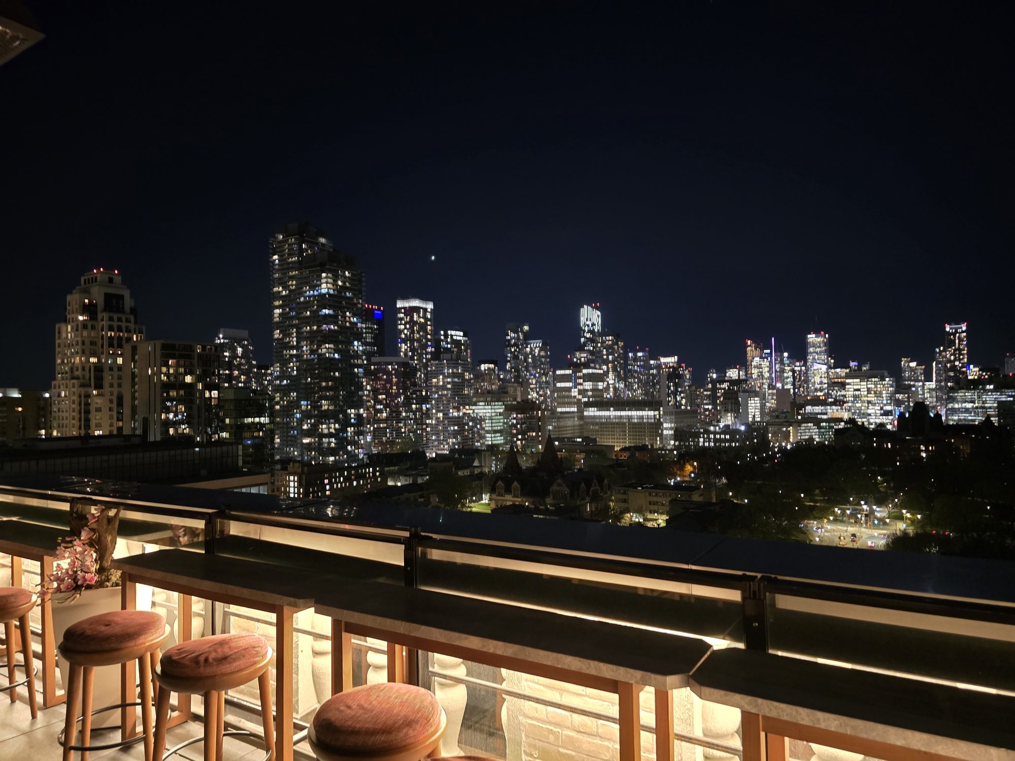 Rooftop bar overlooking illuminated city skyline