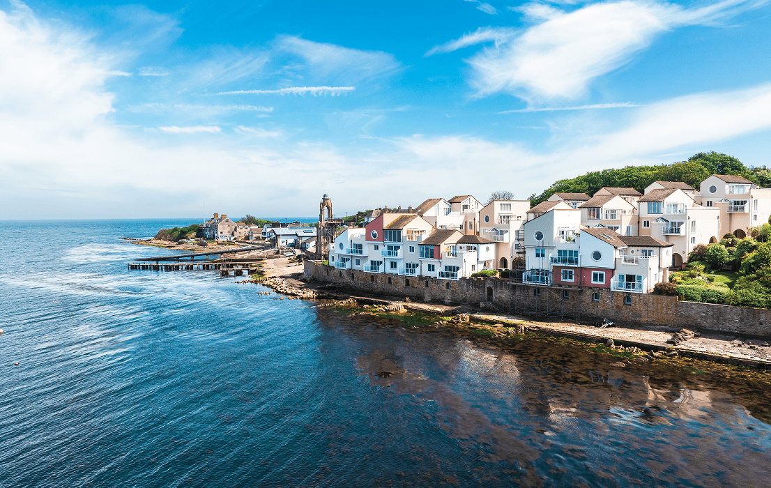Coastal village houses along calm blue sea